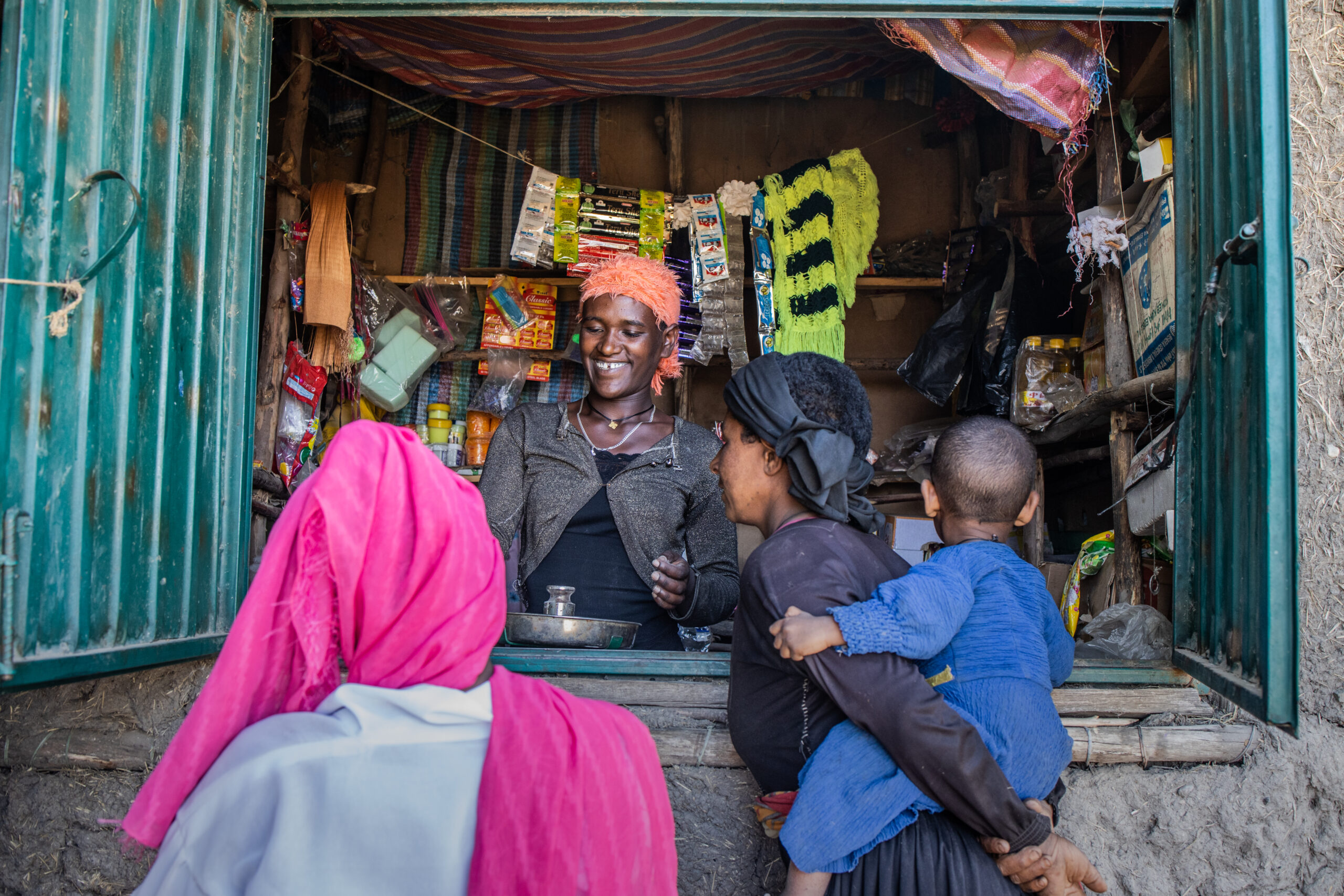 A shopkeeper sells nutritious porridge flour to families from her shop in Ethiopia