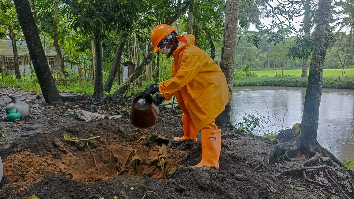 A sweeper empties a pit latrine as a paid service in southwest Bangladesh.