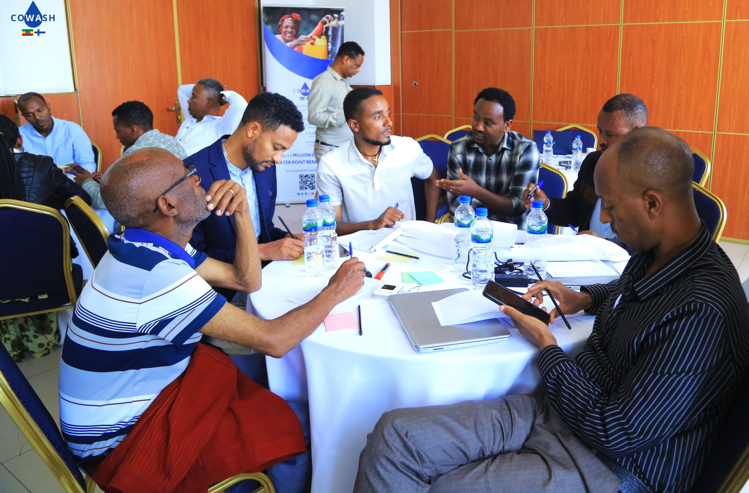 Participants work through joint planning at a round table during the review meeting