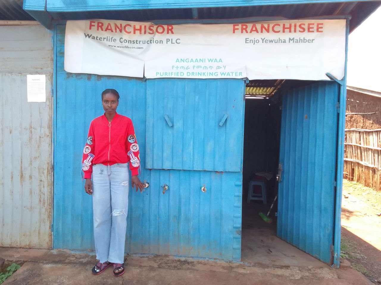 The water kiosk in Shebedino, with a banner naming WaterLife Construction as franchisor and Enjo Yewuha Mahber as franchisee