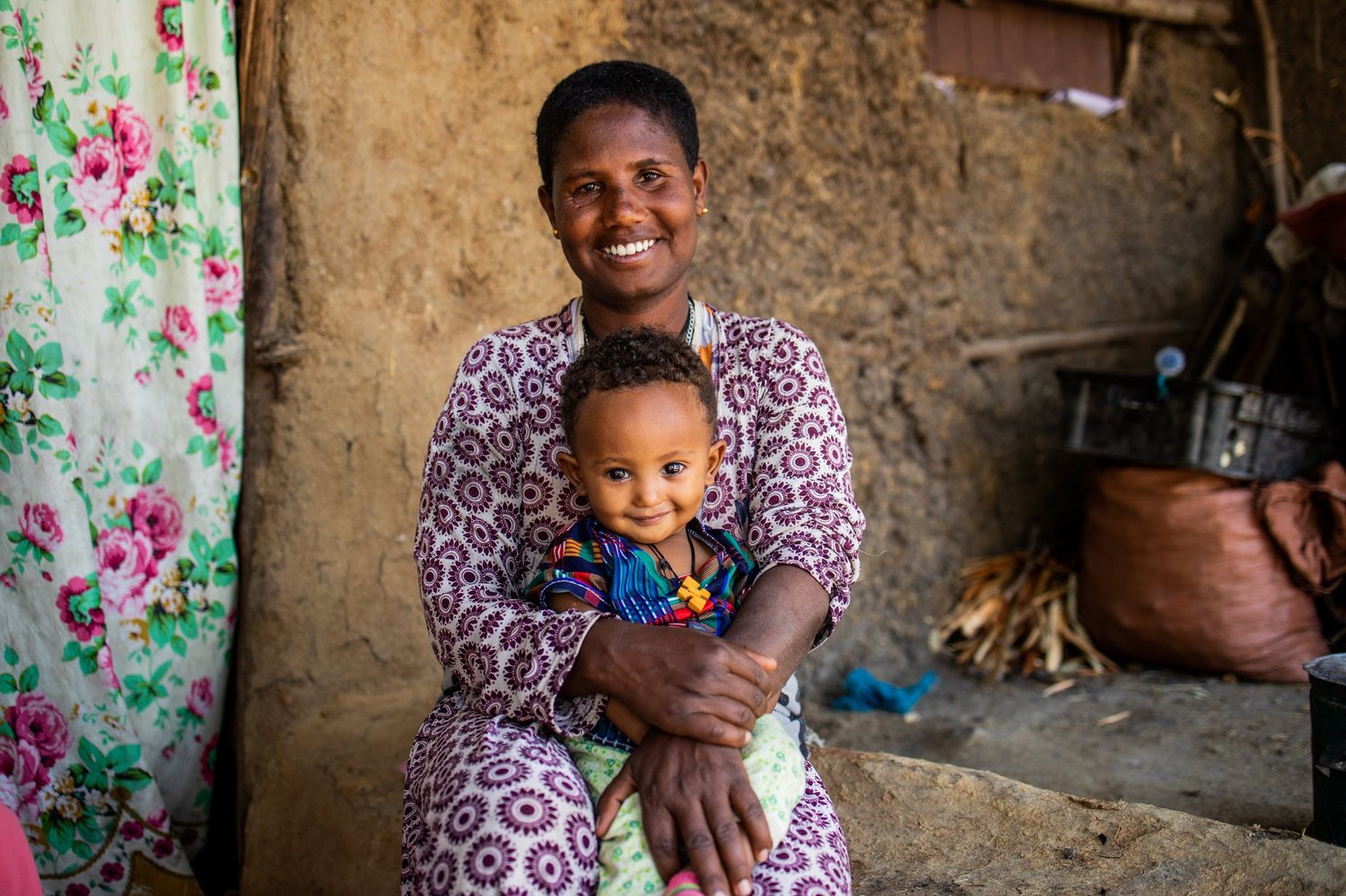 A mother holds her young son at home in East Gojjam, Ethiopia.