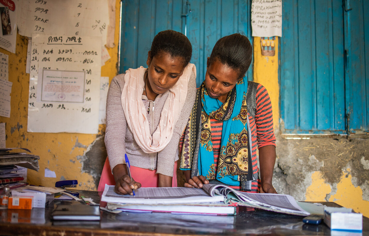 Two Health Extension Workers review growth monitoring records at their health post in Ethiopia